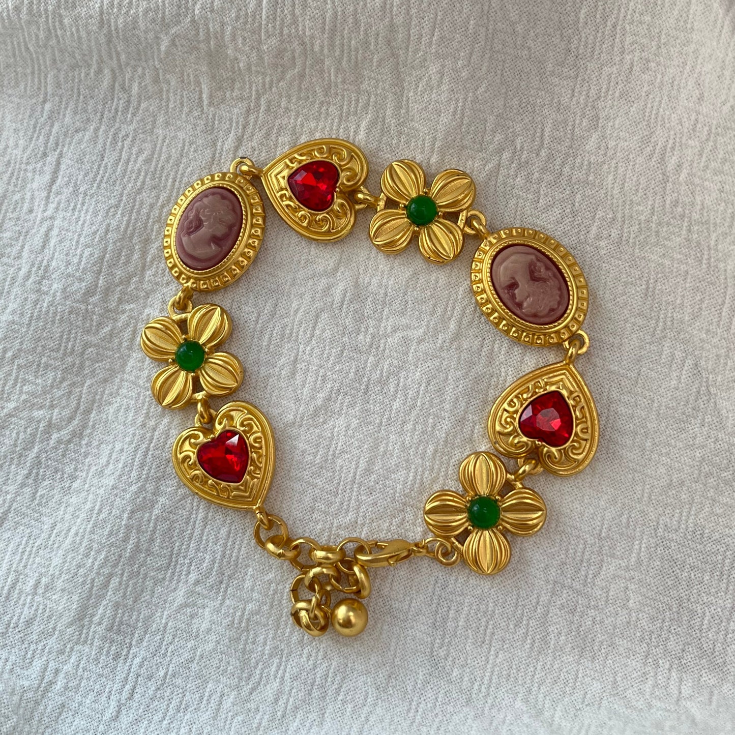 Pulsera vintage dorada con piedras preciosas y corazón de flores
