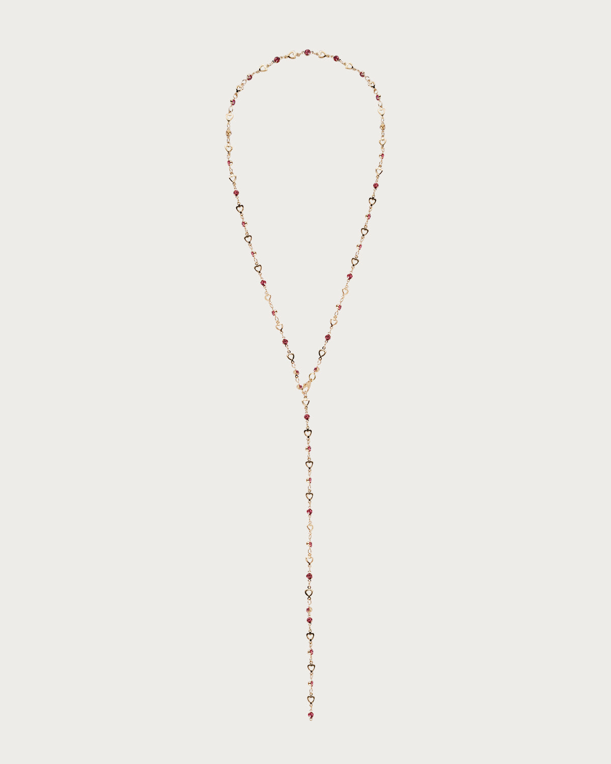 Collar de lazo dorado con corazón pequeño en rosa