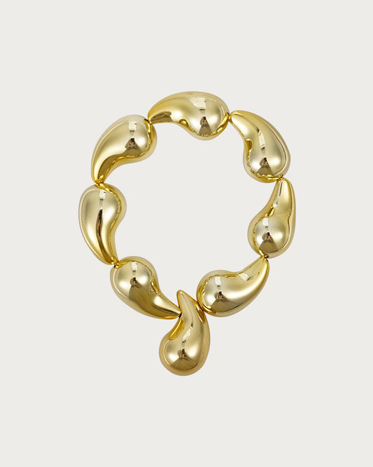Pulsera elástica dorada con gotas de agua