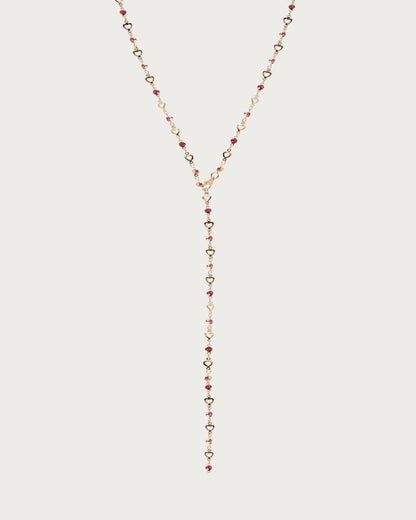 Collar de lazo dorado con corazón pequeño en rosa